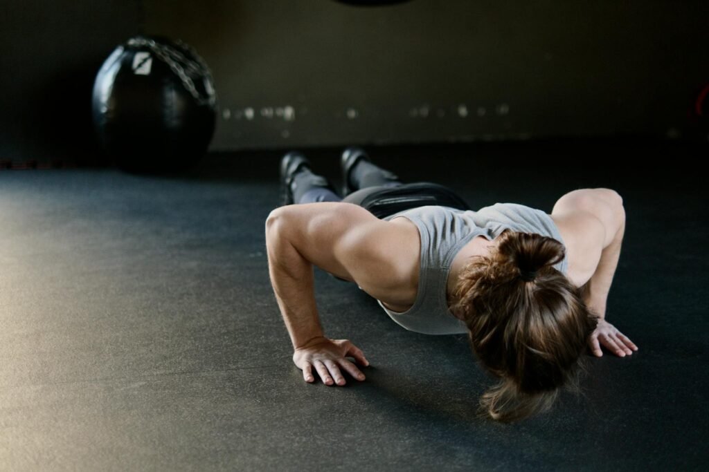 A woman performing a strength training exercise, a key pillar of sustainable fat loss.