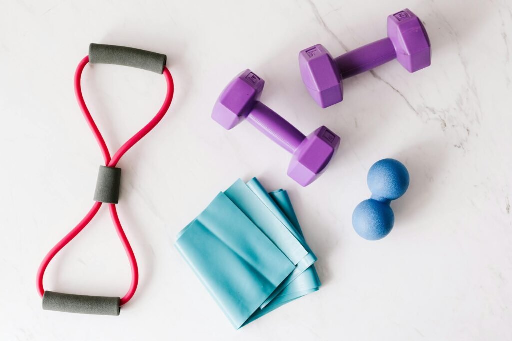 Essential home workout equipment including dumbbells and resistance bands for effective at-home training.